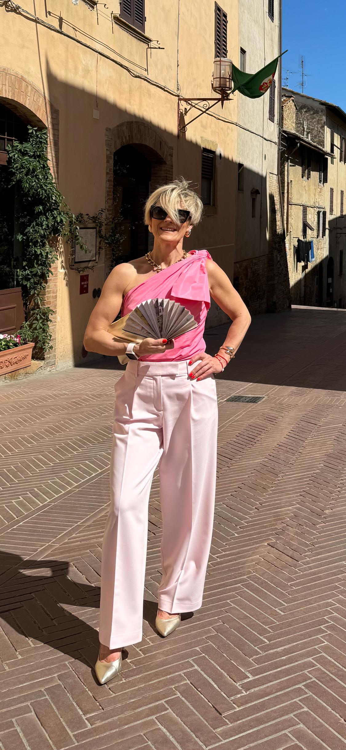 Rita in Tuscany today, wearing a pink and white outfit.