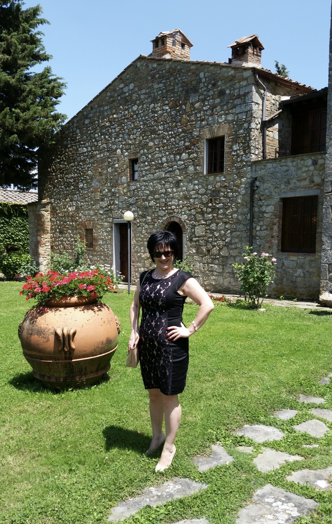 Rita in Tuscany in an earlier chapter of her life, wearing a black dress.